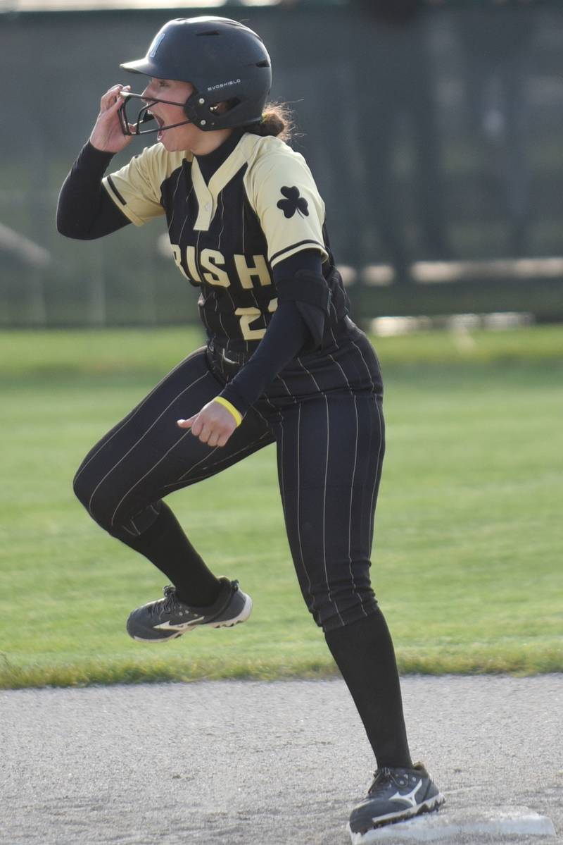 Bishop McNamara's Gabby Burnett gestures to the Fightin' Irish dugout after her three-run double during a home game against Bradley-Bourbonnais Thursday, May 8, 2026.