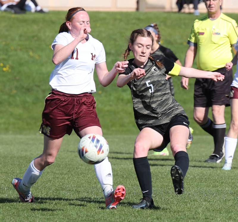 Sycamore's Grace Parks kicks the ball away from Morris' Makensi Martin during their Interstate 8 Conference Tournament semifinal game Wednesday, May 3, 2023, at Sycamore High School.
