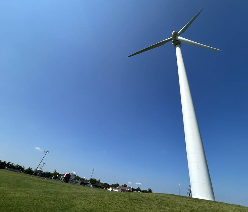 A lone wind turbine sits next to the Erie Middle School in Erie on Friday, July 12, 2024..
