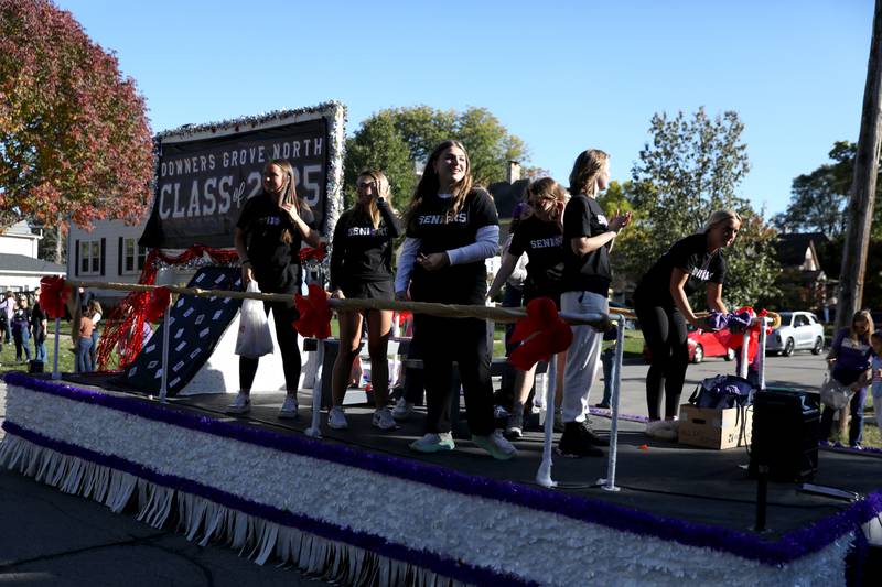 Downers Grove North seniors ride on a float on Friday, Oct. 18, 2024 during the school’s annual homecoming parade.