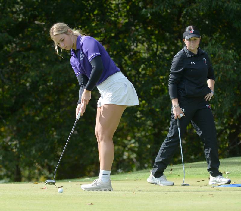 Dixon's Reese Dambman putts as Forreston's Aspen McGlynn watches during the 1A regional at Wolf Hollow Golf Course in Lena on Tuesday, Oct. 1, 2024. Dambman led Dixon with an 80.