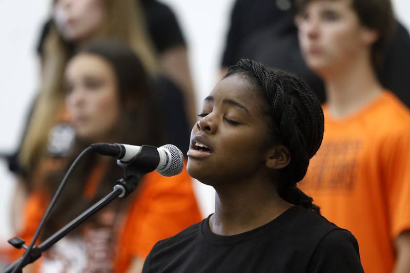 McHenry High School senior Molara Fashola sings the song "MLK" with other members of the choir during a celebration for veterans returning an Honor Flight trip to Washington D.C. on Sunday, Aug. 27, 2023, at McHenry Community High School’s Upper Campus.