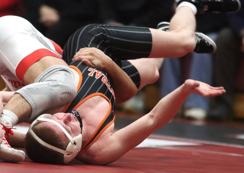Crystal Lake Central’s Peyton Ramsey tries to escape Huntley’s Cameron Abordo at 120 pounds in varsity wrestling on Friday, Dec. 13, 2024 at Huntley High School in Huntley.