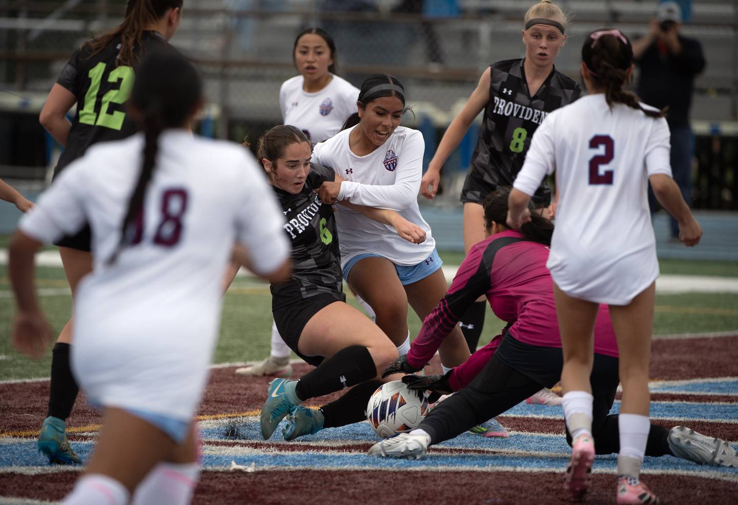 Providence Catholic's Quinn Zdralevich, center, attempts to score as Kankakee's Jasmine Torres, center right, defends and Kankakee's keeper Chloe Perez moves out to make a save during the Class 2A Regional Championship at Kankakee High School on Friday, May 22, 2026.