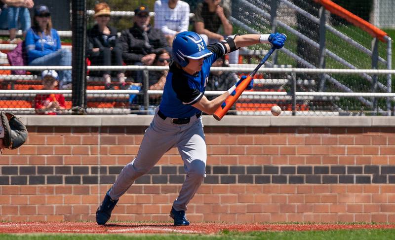 St. Charles North's Will Vaske (2) drives in a run on a bunt against St. Charles East during a baseball game at St. Charles East High School on Saturday, May 7, 2022.