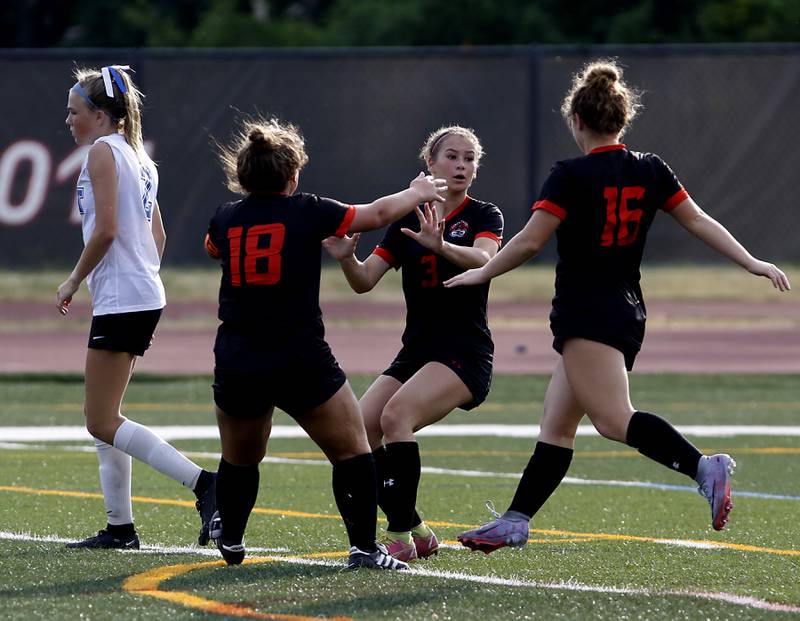 Libertyville’s Jenna Krakowski (left) and Shea Krakowski (right) rush to congratulate Molly Koch after she scored the winning goal during the IHSA Class 3A state third-place match against  Lincoln-Way East at North Central College in Naperville on Saturday, June 3, 2023.