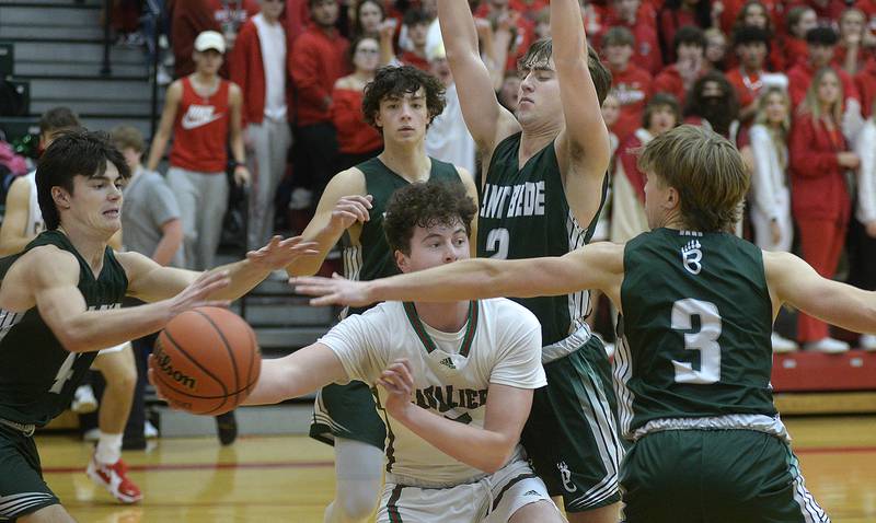 Surrounded by the Bruin defense LaSalle Peru’s Tommy Hartman makes a pass around St Bede’s Callan Hueneburg in the 2nd period on Saturday, Jan. 28. 2023 at LaSalle Peru High School.