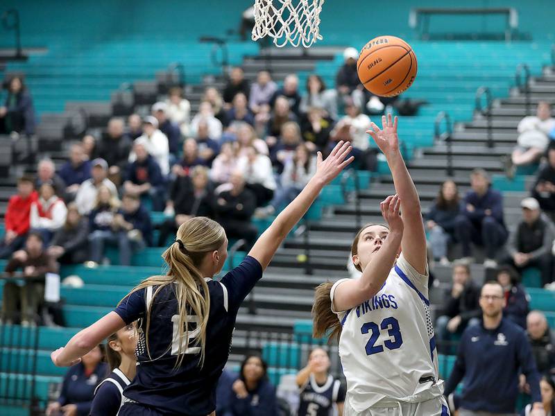 Geneva's Nora Hatton (right) drives to the basket agains tSt. Viator's Emily Walberg during the IHSA Class 3A Woodstock North Supersectional girls basketball game on Monday, March 2, 2026, at Woodstock North High School.