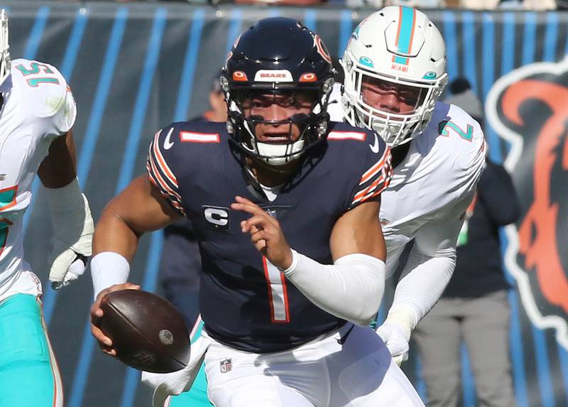 Chicago Bears quarterback Justin Fields scrambles away from Miami Dolphins linebacker Bradley Chubb during their game Sunday, Nov. 6, 2022, at Soldier Field in Chicago.