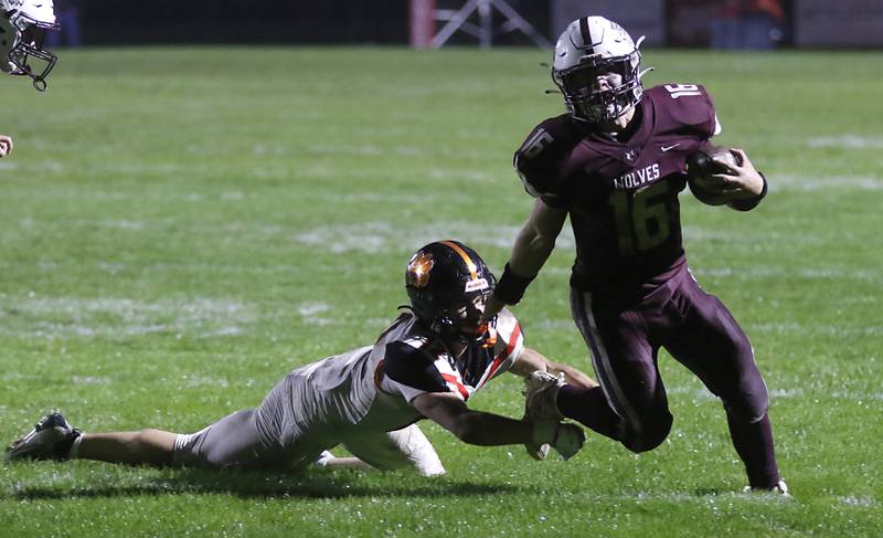 Prairie Ridge's Dominic Creatore runs out of the tackle attempts of Crystal Lake Central's Rene Gaunaurd during a Fox Valley Conference football game on Friday, Oct. 13, 2023, at Prairie Ridge High School in Crystal Lake.