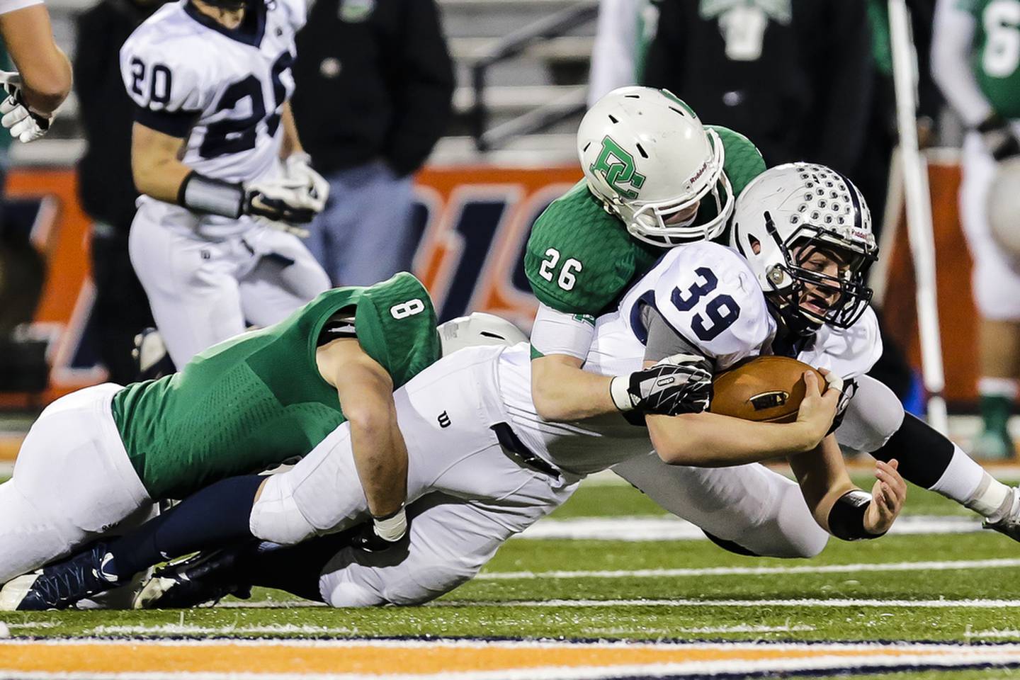 Cary-Grove's Tyler Pennington is tackled by Providence Catholic;s Emmer Trost(8) and Erik Carroll(26) during the first half of the IHSA class 7A state championship game at the University of Illinois Urbana-Champaign, Saturday, Nov. 29, 2014, in Champaign, Ill.