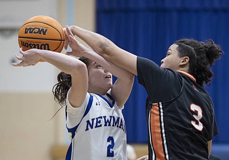 Newman’s Helen Papoccia is fouled by Kewanee’s Mya Dearing Thursday, Feb. 6, 2025, at Newman High School.