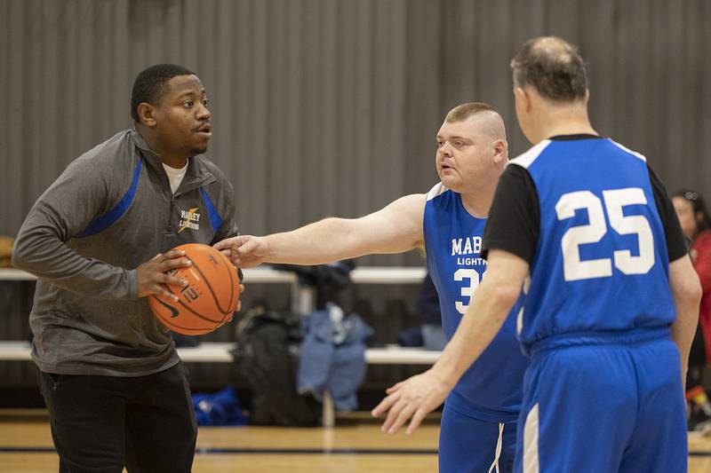 Coach Eli Townsend runs defensive practice against Joe Wednesday, Dec. 18, 2024, during Special Olympic basketball practice.