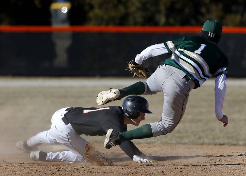 Crystal Lake Central's Drew Welder hangs onto second base as Boylan's Henry Berg flies past Welder after Berg lost the ball trying to tag out Welder during a nonconference baseball game Wednesday, March 29, 2023, at Crystal Lake Central High School.