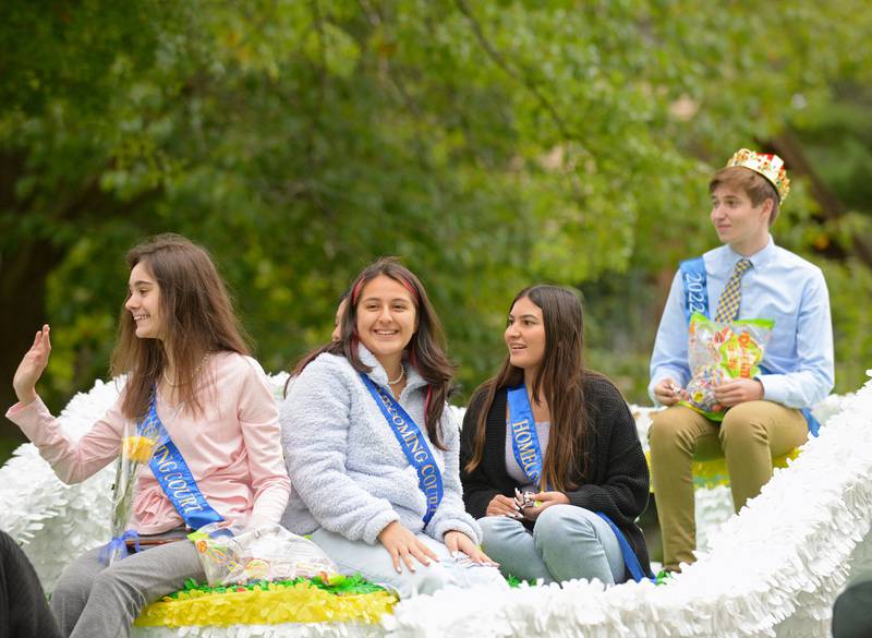 Members of the Lyons Township High School homecoming court ride high on their float in La Grange, heading for Western Springs in the annual homecoming parade on Saturday, Sept. 24, 2022.