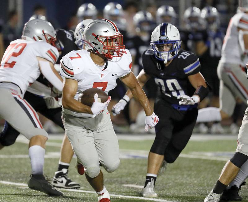 Palatine's Dominik Ball (7) turns upfield for a long 60 yard touchdown Friday August 25, 2023 in St. Charles.