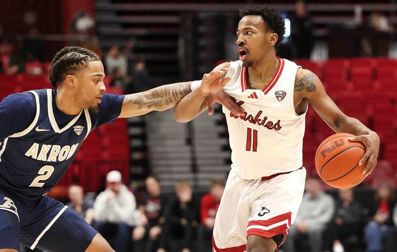 Northern Illinois' David Coit is guarded by Akron's Greg Tribble during their game Tuesday, Jan. 2, 2024, in the Convocation Center at NIU in DeKalb.