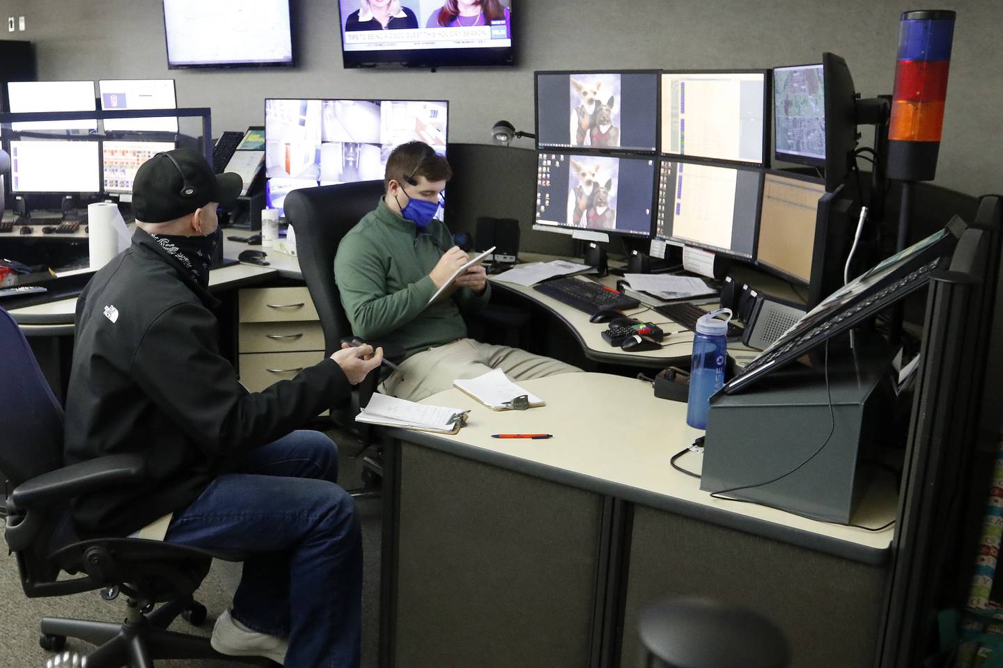 SEECOM telecommunicator trainer Mike Jurkowski, left, works with Jim Epley on the phones and computer systems that connect 911 calls to first responders on Wednesday, Dec. 22, 2021, at Aaron T. Shepley City Hall in Crystal Lake.