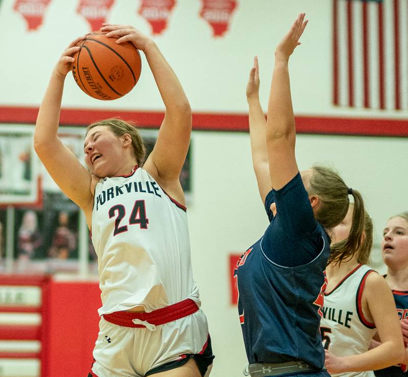 Yorkville's Ava Diqui (24) grabs an offensive rebound against Oswego during the 13th annual Hoops 4 Hope Communities vs. Cancer basketball event at Yorkville High School on Saturday, Jan 28, 2023.