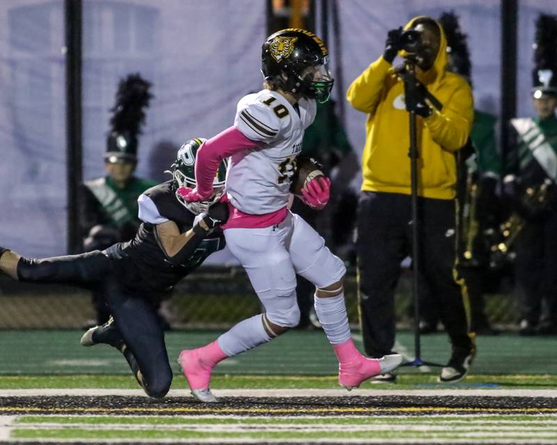 Joliet West's Parker Schwarting (10) runs in a touchdown on a short reception before halftime during football game between Joliet West at Plainfield Central.   Oct 20, 2023.