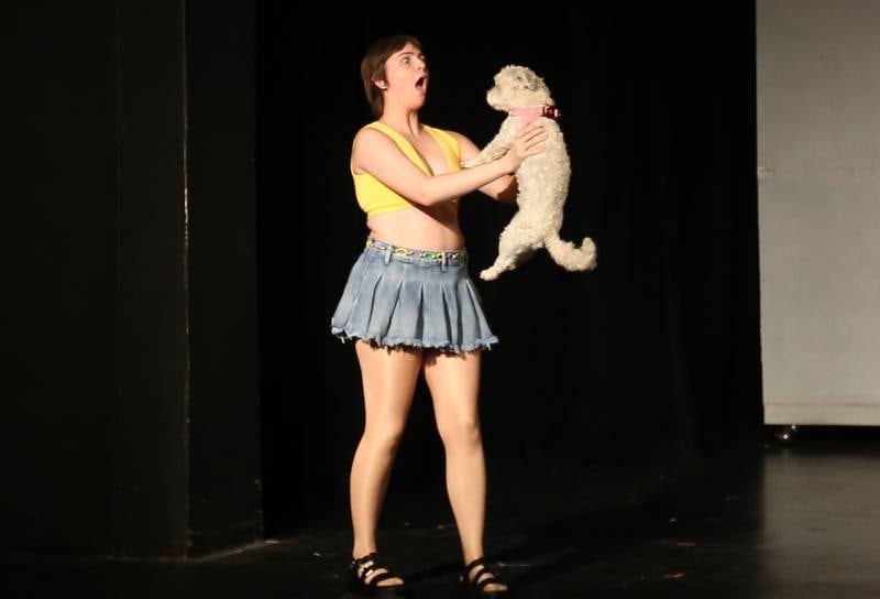 Margot Chapman played by Nora Maier, holds Bruiser Woods while acting out a scene during a rehearsal of Legally Blonde on Tuesday, July 1, 2025 at Stage 212 in La Salle.
