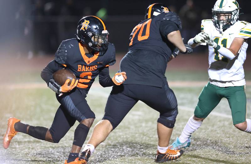 DeKalb's Jamari Brown follows the block of Anthony Fabricino as he tries to get by Waubonsie Valley's Bryce Provis during their game Thursday, Oct. 20, 2022, at DeKalb High School.