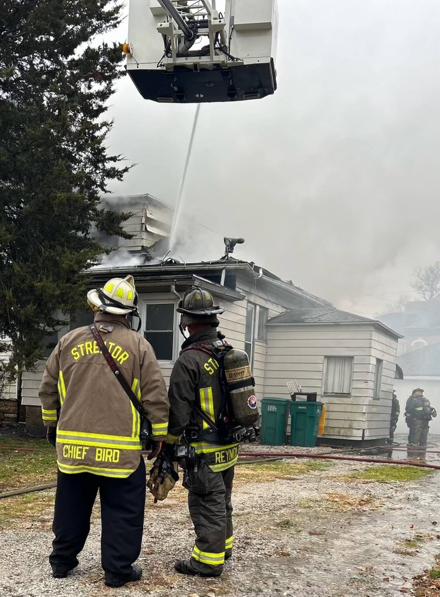Chief Gary Bird and Captain Ryan Reynolds review the situation as firefighters from the Streator Fire Department work to extinguish a blaze.