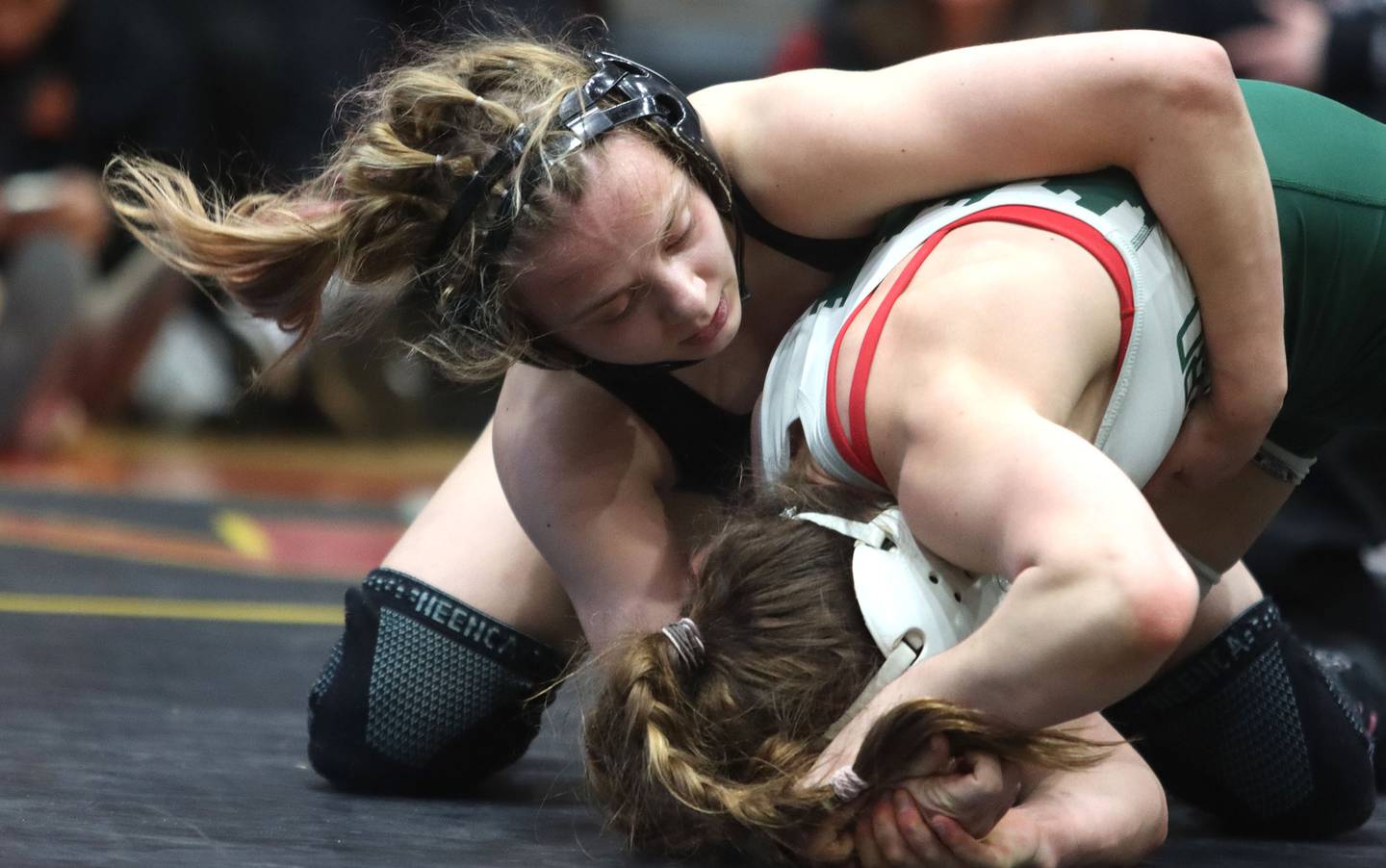 Hampshire’s Amelia Nidelea-Polanin, top, battles Glenbard West’s Karolina Konopka at 120 pounds in the title bout of  varsity girls IHSA Sectional wrestling on Saturday, February 14, 2026, at Schaumburg High School in Schaumburg.