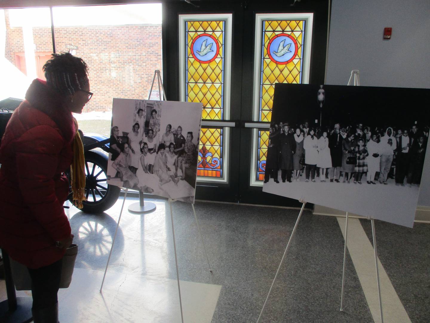Diane Harris looks at historical photos on display in the entryway of the Joliet Area Historical Museum on Saturday for the "History in Our Hands" event at the Joliet museum. Feb. 22, 2025