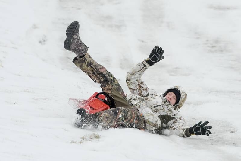 John Ruppert, 15 of Cincinnati Ohio swipes out as he sleds down the hill at Hopkins Park in DeKalb on Wednesday, Dec. 30, 2020.
