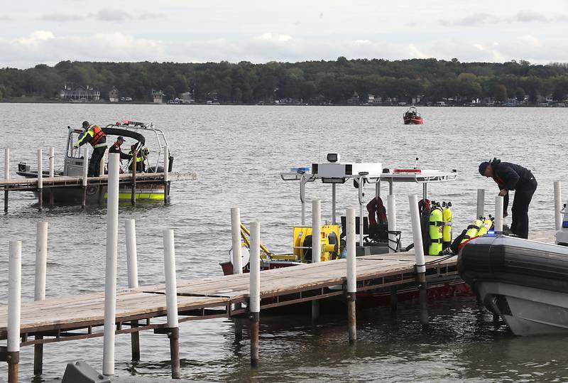 Divers from the Antioch Fire Protection District and a sonar team from the Illinois Department of Natural Resources continue searching Tuesday, Oct. 7, 2025, on Fox Lake near Antioch for a man thrown from a boat he was test driving Monday night.