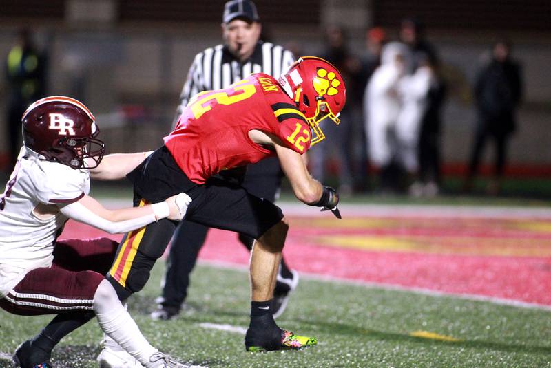 Batavia’s Luke Alwin (right) gets away from Brother Rice’s Conner Stack to score a touchdown during a Class 7A round 1 playoff game in Batavia on Friday, Oct. 27, 2023.