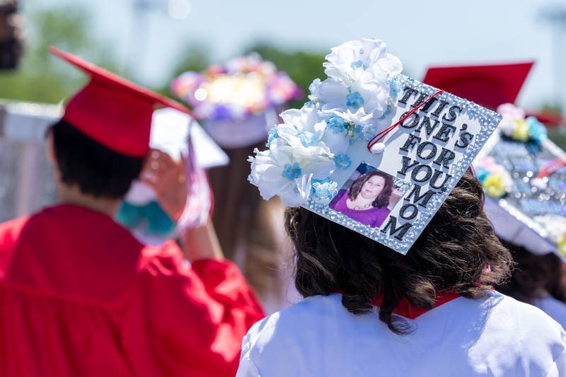 Graduate enters football field with decorated cap on Sunday, May 18, 2025 at Hall High School in Spring Valley.