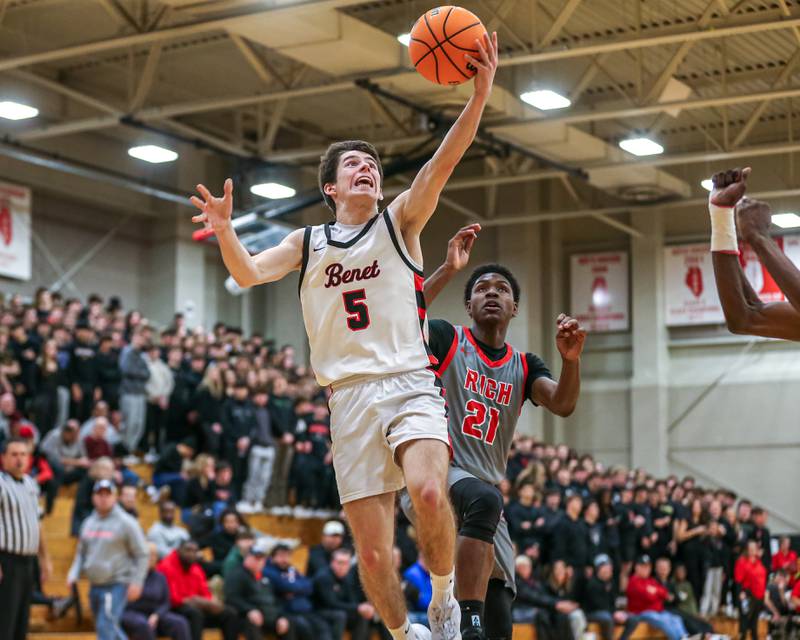 Benet's Michael Doyle (5) goes in for a layup during their When Sides Collide Shootout basketball tournament matchup between Rich Township at Benet Academy. Jan 25, 2025 in Lisle.