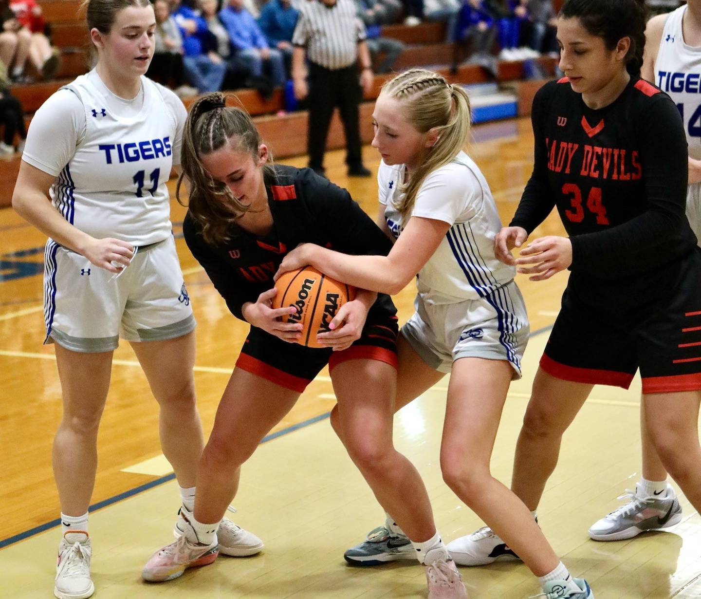 Hall's Kennedy Wozniak and Princeton's Paige Jesse wrestle for the ball in Thursday's game at Prouty Gym. The Tigresses won 34-30.