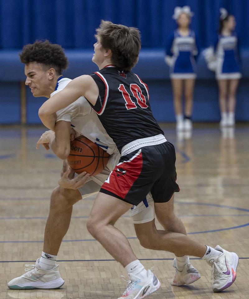 Newman’s Isaiah Williams and Hall’s Greyson Bickett fight for the ball Friday, Feb. 2, 2024 at Newman High School.