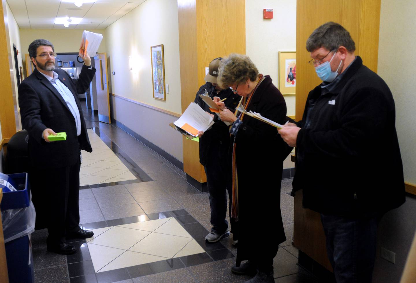 McHenry County Clerk Joe Tirio speaks to candidates as they wait to file their candidate forms the morning of Monday, March, 7, 2022, at the McHenry County Clerk's Office in Woodstock. Monday was the first day for candidates to file ahead of the June primaries. This election season includes all McHenry County Board seats, the clerk, sheriff and regional superintendent of education. The candidates were trying to get the first slot on the ballot by filling at 8 a.m. When more than one candidate applies at a time, a lottery is held.