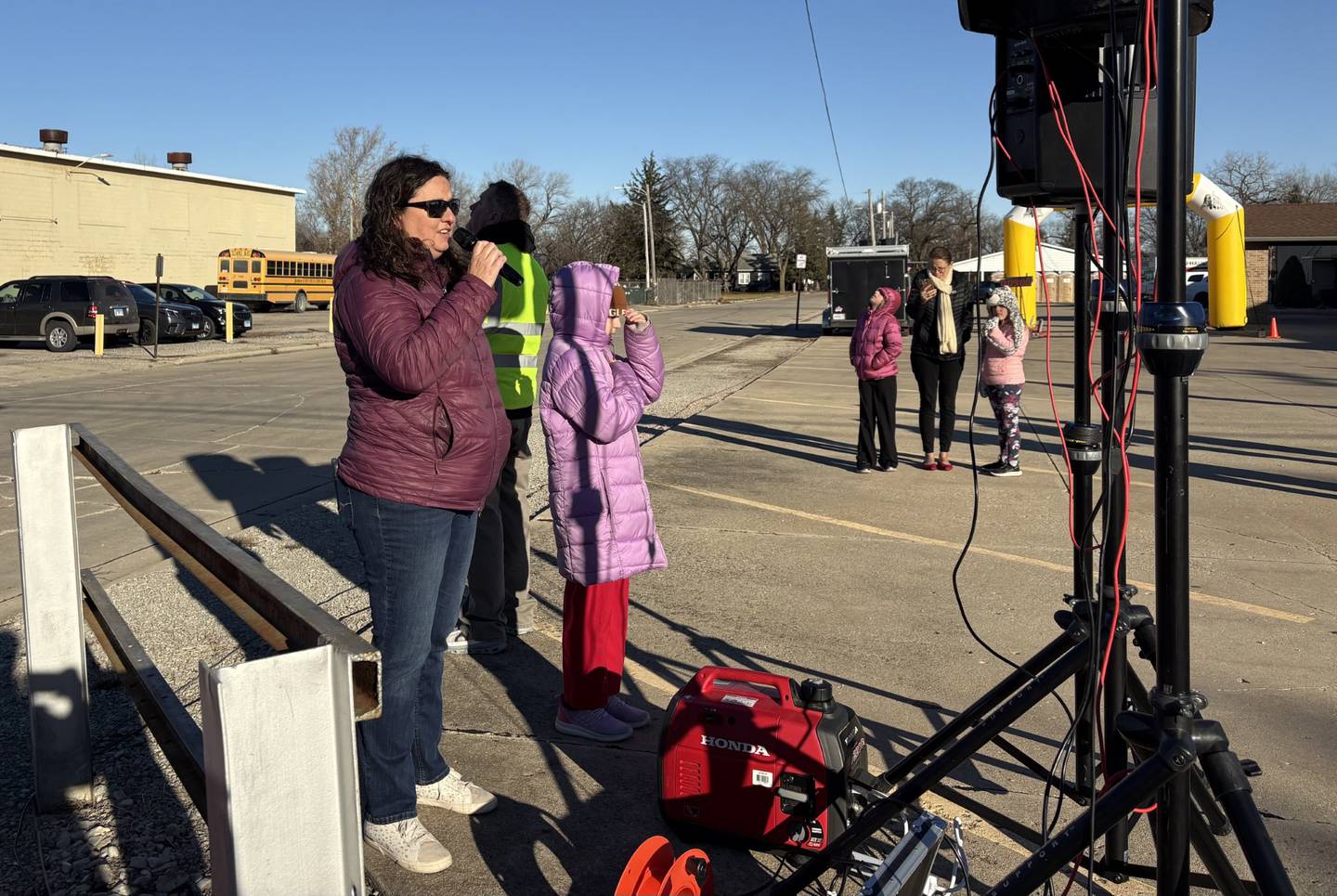Jenilyn Roether of Peru, who has performed the national anthem at the Turkey Trot for 16 years, sings before the start of Thursday’s race.