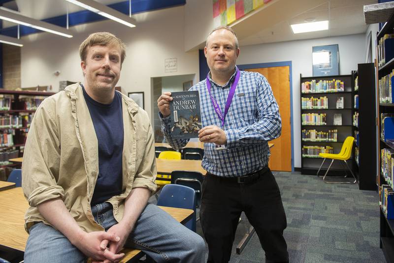 Reagan Middle School teachers John Taylor, left, and Eric Ferguson collaborated on a self-published book. Taylor designed the front and back covers while Ferguson penned the tale of “The Adventures of Andrew Dunbar.”