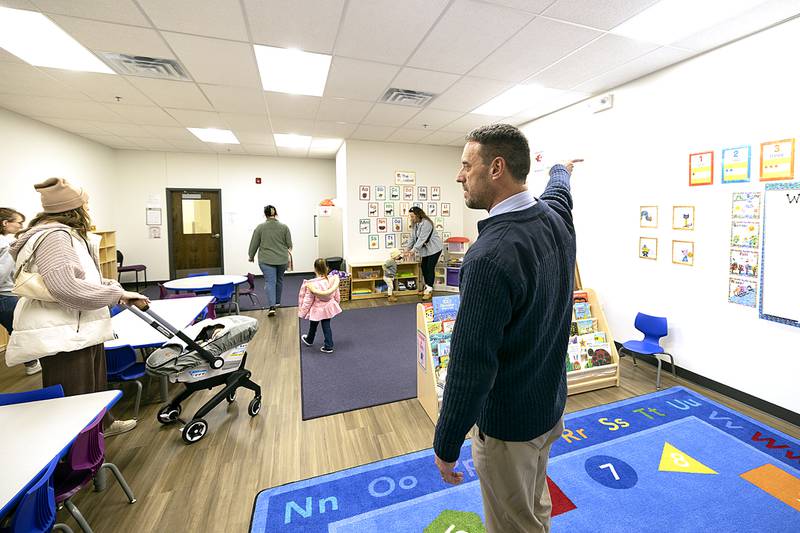 Dixon YMCA director Andrew McFarlane gestures while directing visitors to the new child care center Thursday, Jan. 9, 2025.