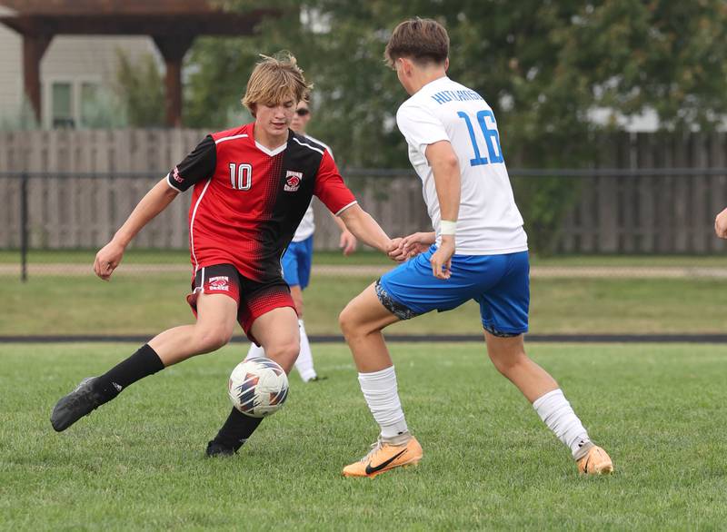 Indian Creek's Parker Murry (left) tries to get by Hinckley-Big Rock's Daniel Hutchinson during their game Wednesday, Sept. 20, 2023, at Pack Park in Waterman.