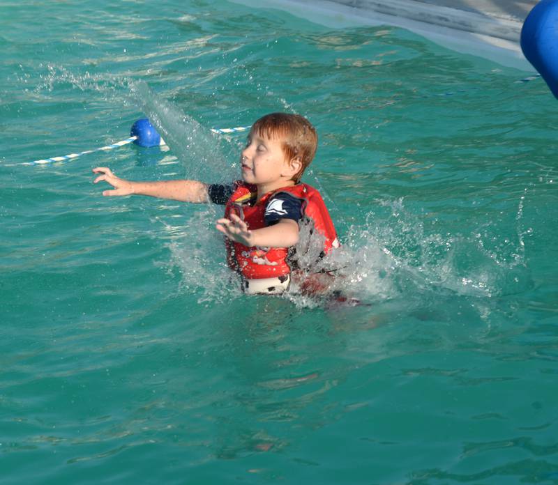 Ryder Roe, 6, of Polo, paddles away from the slide at the Polo Pool on Thursday, Aug. 24, 2023. The pool was open from 5-8 p.m. during the recent hot spell to give people a place to cool down.