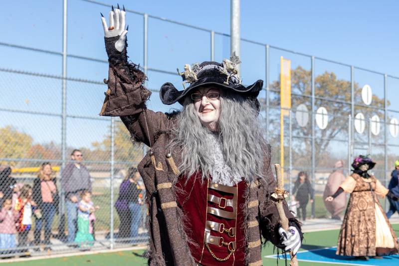 A which of the “Hocus Pocus Hags” waves at the annual trick or treat at Washington park on Saturday, October 26, 2024 in Peru.