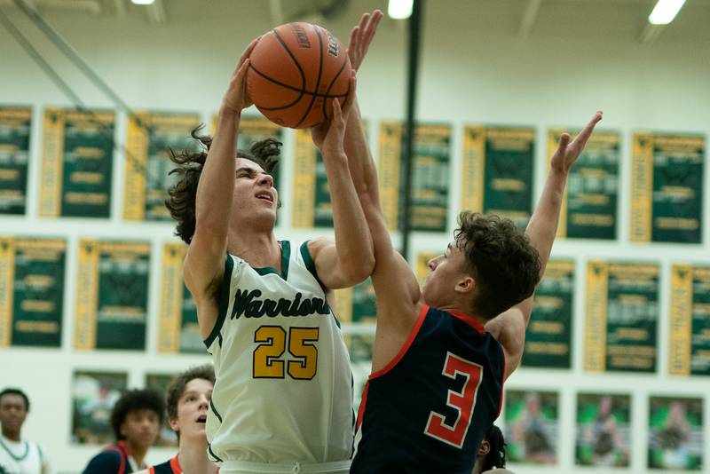 Waubonsie Valley's Jackson Langendorf (25) shoots the ball in the post against Oswego’s Max Niesman (3) during a Waubonsie Valley 4A regional semifinal basketball game at Waubonsie Valley High School in St.Charles on Wednesday, Feb 22, 2023.