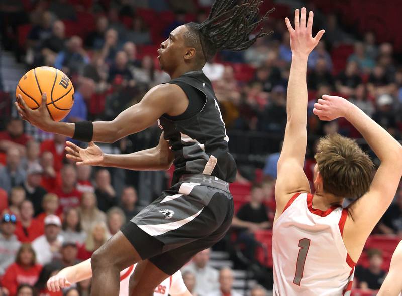 Kaneland's Marshawn Cocroft goes by Morton's Jude Zeller Monday, March 9, 2026, during their IHSA Class 3A supersectional matchup in the Convocation Center at Northern Illinois University in DeKalb.