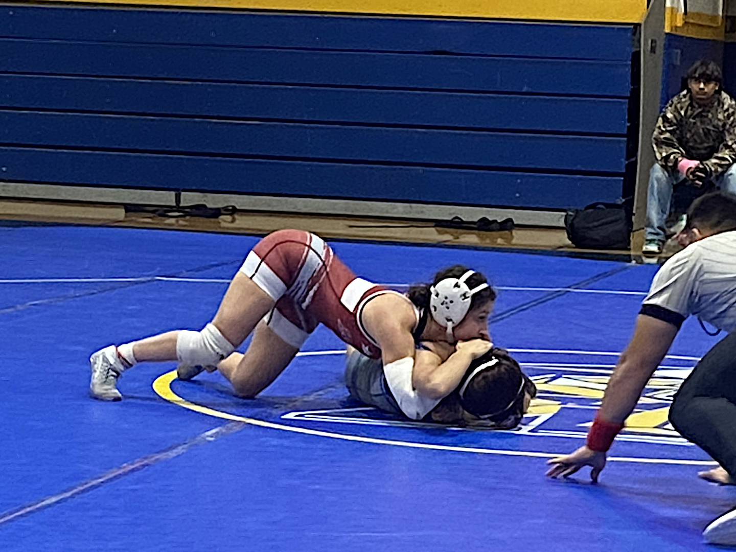 Lockport's Averi Colella (left) goes for a pin against Joliet Central's Valerie Ruiz-Flores.
