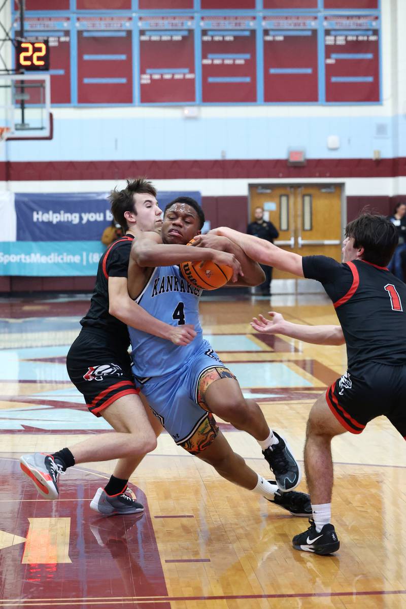 Kankakee's Myair Thompson protects the ball on a drive through two defenders during the Kays' 54-50 victory over Lincoln-Way Central in the 75th Kankakee Holiday Tournament maroon bracket championship on Sunday, Dec. 28, 2025.