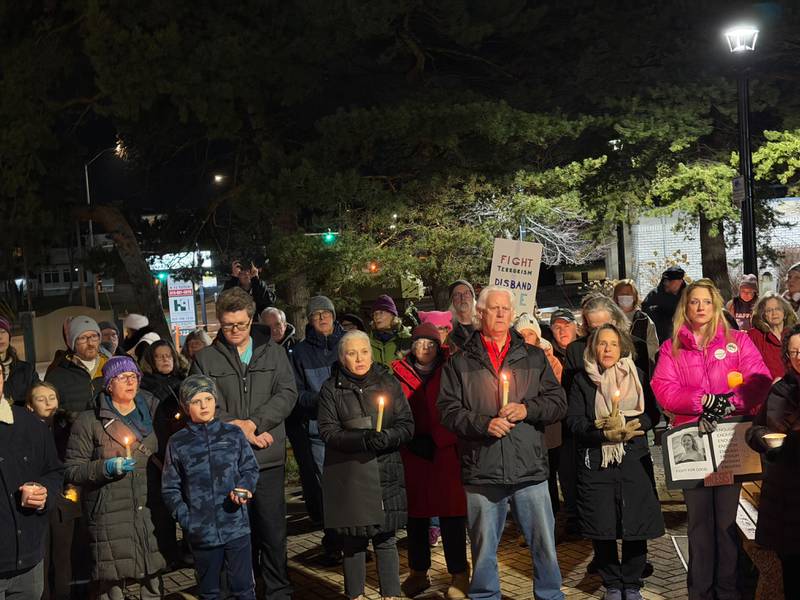 A large crowd holds candles and gathers in downtown DeKalb at Memorial Park on Friday, Jan. 9, 2026, for a vigil to remember the life of Renee Nicole Good, 37, a Minnesota mother who was shot and killed by a federal immigration agent in Minneapolis on Jan. 7, 2026. Organizers said the vigil was meant to provide a peaceful place to mourn as President Donald Trump's violent immigration enforcement sweeps across the country grow more divisive.