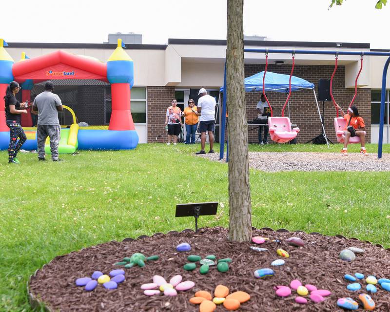Painted rocks are seen displayed on the ground underneath a memorial tree planted to honor the life of the late Ezra Hill Jr., 10, a DeKalb boy who was fatally shot in 2019. The Ezra Hill Jr. Memorial Foundation’s 5th annual rock painting event was held on Saturday, June 7, 2025, at Tyler Elementary School in DeKalb.