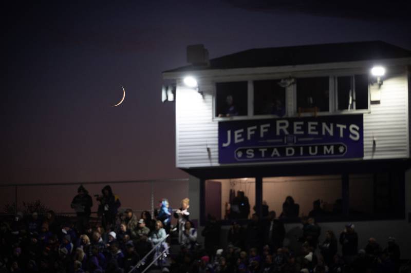 A waxing crescent moon rises over Wilmington at the start of the Class 2A football semifinal with Wilmington and El Paso-Gridley on Saturday, November 22, 2025.